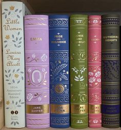 a row of books sitting on top of a wooden shelf next to each other in a book case