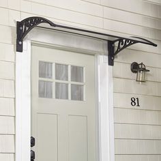 a white door with black brackets on the side and numbers on the front wall below it