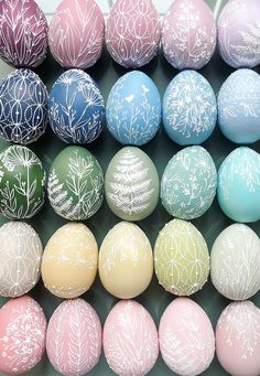 an assortment of painted eggs sitting on top of each other in different colors and patterns