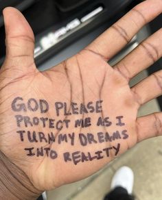 a hand with writing on it that says god please protect me as i turn my dreams into reality