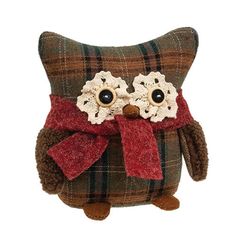 a stuffed owl with a red bow on it's head and eyes, sitting in front of a white background