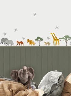 an elephant and giraffes wall decals in a children's bedroom