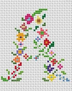 a cross stitch pattern with flowers and leaves on white background, in the shape of a letter