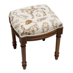 an upholstered foot stool with horses on it