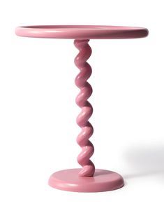 a pink table with a spiral design on the top and bottom, against a white background