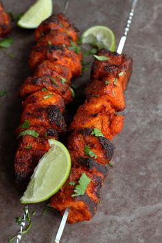 chicken skewers with lime and cilantro garnish on a stick