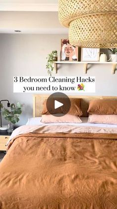 a bed room with a neatly made bed and a hanging basket over the headboard