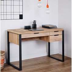 a wooden desk with black metal legs and an orange light hanging from the ceiling above it