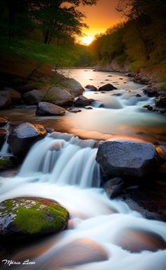 the sun is setting over a small waterfall