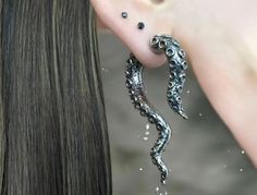 Dive into the depths of unique style with our Octopus Tentacle Earrings. Crafted from high-quality, hypoallergenic materials, these earrings feature intricately detailed tentacles that wrap elegantly around your earlobes.  Available in sleek silver, each piece embodies a touch of oceanic allure and sophistication. Perfect for adding a hint of the fantastical to any outfit, these earrings are versatile enough for both casual and formal occasions.  Embrace your inner sea siren and make a statement Tentacle Earrings, Octopus Cute, Sea Siren, Earrings Funky, Octopus Tentacles, Gothic Earrings, Sea Creature, Kraken, Cute Gift