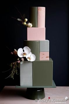 a multi - tiered cake with flowers on the top and bottom is green, pink, gray, and white