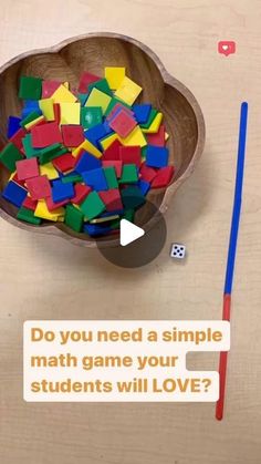 a wooden bowl filled with lots of different colored blocks next to a pencil and eraser