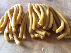 some kind of food that is on a wooden table with it's peels cut in half