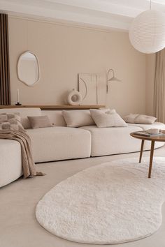 a living room filled with furniture and a white rug