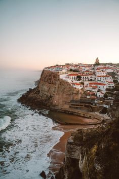 an ocean view with houses on the cliff