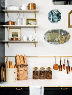 the kitchen counter is covered with spices, breads and other cooking utensils