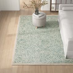 a white couch sitting on top of a hard wood floor next to a living room