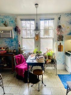 a kitchen filled with lots of furniture and decor