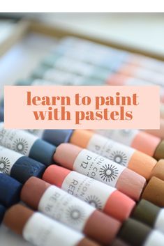 the words learn to paint with pastels are in front of many different colored crayons