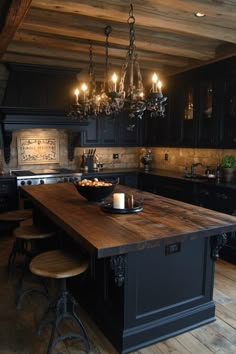 a kitchen with an island and chandelier hanging from the ceiling