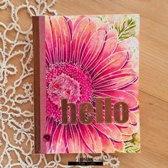 a close up of a book on a table with a lace doily behind it