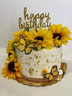 a birthday cake decorated with sunflowers and butterflies