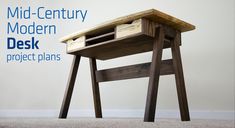 a wooden desk sitting on top of a carpeted floor next to a white wall