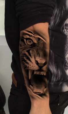 a man with a tiger tattoo on his arm