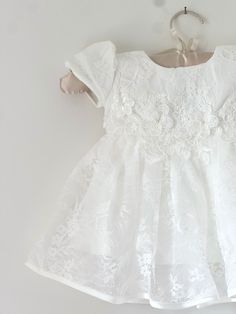 Beautiful and elegant baby girls' lace baptism dress. Two-piece set including a delicately embroidered short-sleeve gown with matching lace bonnet. Complete with a linen and cotton blend liner, to ensure comfort. Feel free to add one of our adorable headbands to complete the look. Fitted Short Sleeve Baptism Dress, Fitted Short Sleeve Baptism Dress For First Communion, White Baptism Dress With Lace Sleeves, White Fitted Short Sleeve Baptism Dress, Lace Baptism Dress With Lace Patchwork, Short Sleeve Lace Dresses For Baptism, Lace Dress For First Communion With Short Sleeves, Short Sleeve Baptism Dress With Lace Work, Elegant Baptism Dress With Short Sleeves