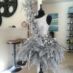 a mannequin with silver and white decorations on it