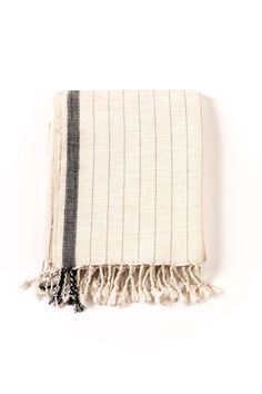 a black and white striped blanket on a white background with fringes in the middle