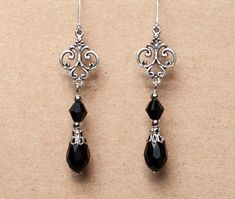 These elegant earrings are made from crystal beads and antique silver filigree. Available in black, red and amethyst. They will make a beautiful accessory for someone who loves Victorian or vintage style accessories. -Made from teardrop and bicone shaped beads, attached to rnate antique silver filigree -The earrings are 2 inches long, without the lever back closure -They have a lever back closure -Available in 3 colors: Black, Amethyst and Red, please select your preferred color from the drop do Victorian Gothic Accessories, Gothic Earrings Victorian, Long Dangly Earrings, Elegant Black Filigree Earrings, Black Elegant Chandelier Earrings, Nickel Free, Antique Silver Filigree Earrings, 1800s Earrings, Maid Levi, Victorian Jewellery Designs