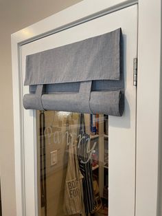 an open door with a curtain hanging from it's side and some bags on the other side