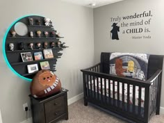 a baby's room with a star wars theme on the wall