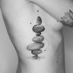 a black and white photo of a man's back with some rocks on it