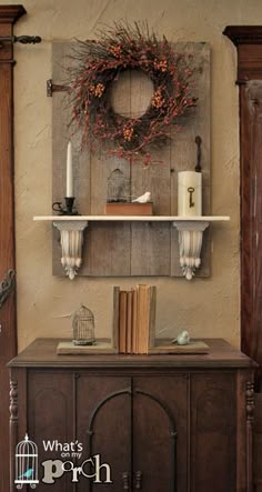 an image of a shelf with books and candles on it