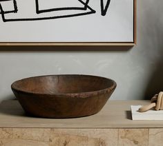 a wooden bowl sitting on top of a table