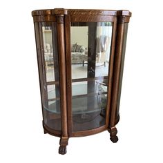 a wooden cabinet with glass doors and wheels