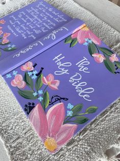 a purple book with flowers painted on it