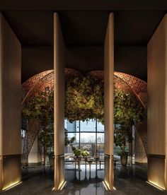 an elegant lobby with columns and plants on the walls