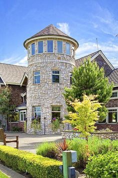 a large house with many windows and plants around it