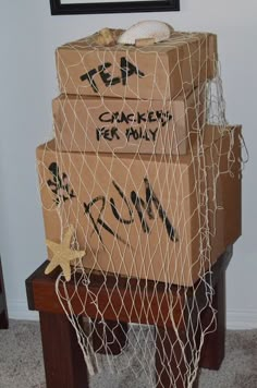 cardboard boxes stacked on top of each other with graffiti written on them and wrapped in netting