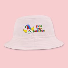 "Fool Time Employee" bucket hat - a quirky and playful nod to clowncore and kidcore aesthetics. Featuring a vibrant clown graphic, this hat is perfect for anyone embracing their inner fool or adding a splash of fun to their wardrobe. Made for those who love bold, colorful, and nostalgic styles, this bucket hat is both a fashion statement and a reminder not to take life too seriously. Whether you're rocking it at a festival or just hanging out, this hat will keep the laughs coming! .: Material: 100% polyester .: Available in 2 sizes .: Sewn-in label .: Made in USA Clown Clothing, Pastel Clown, Kidcore Aesthetic, Funny Gift Idea, Sew-in Labels, The Fool, Funny Gifts, Fashion Statement, Caps Hats