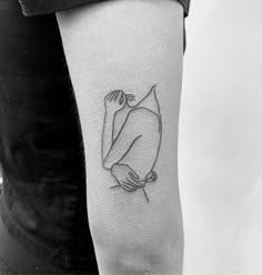 a black and white photo of a woman's arm with a tattoo on it