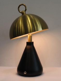 a black and gold lamp on a white table