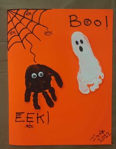 a handprinted halloween card with a ghost and a spider on an orange background