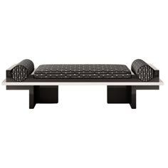 a black and white bench with two pillows on it's seat cushions are placed at the end