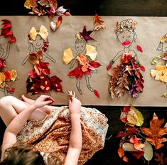 two children are playing with autumn leaves