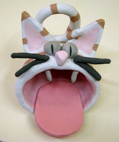 a close up of a stuffed animal with its mouth open and tongue hanging out to the side