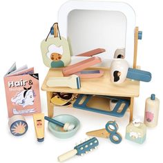 an assortment of children's toys sitting on top of a wooden table next to a mirror